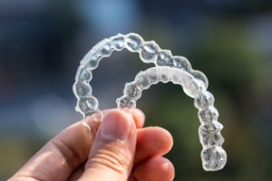 holding up invisalign mouth guard set